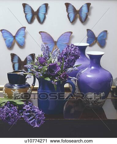 Still-Life of blue Spring flowers in jug with blue vases and butterflies View Large Photo Image Stock Image - Still-Life of blue Spring flowers in jug with blue vases and butterflies. Fotosearch