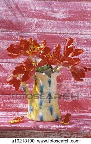 Stock Image - Still-Life of red tulips in jug. Fotosearch