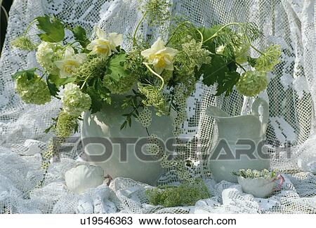 Stock Image - Still-Life of white jugs and flowers. Fotosearch