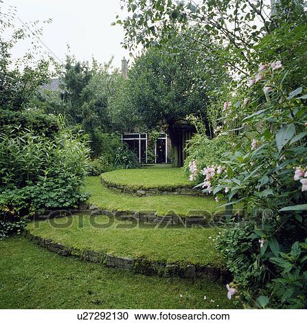 Stone edging on curved grass steps View Large Photo Image Stock Image - Stone edging on curved grass steps . Fotosearch
