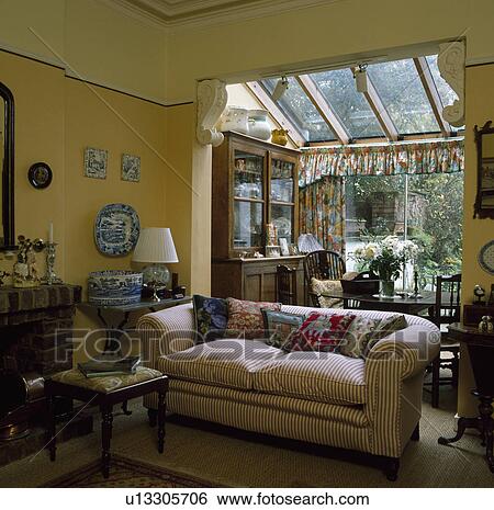 Striped sofa in living room with glass-roofed dining room extension View Large Photo Image Stock Photograph - Striped sofa in living room with glass-roofed dining room extension. Fotosearch