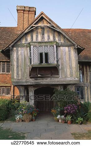 Stock Photography - Summer flowering plants in front of timbered Tudor house. Fotosearch