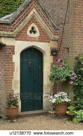 Summer flowering plants in pots on either side of black front door in brick porch View Large Photo Image Stock Image - Summer flowering plants in pots on either side of black front door in brick porch. Fotosearch