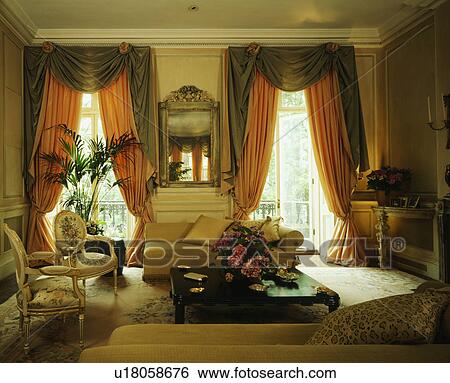 Stock Photograph - Swagged curtains in traditional living room. Fotosearch