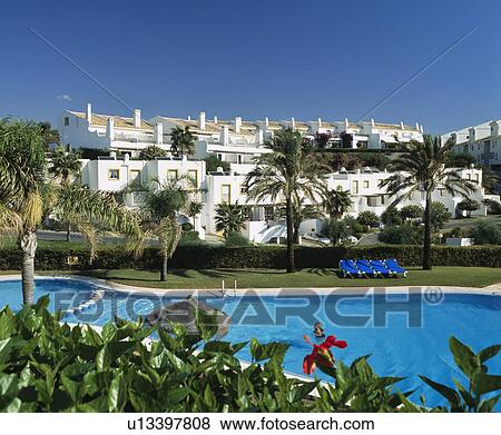 Swimming pool in front of holiday village apartments View Large Photo Image Stock Photo - Swimming pool in front of holiday village apartments. Fotosearch