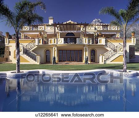 Stock Image - Swimming pool in front of large modern villa in Southern Spain. Fotosearch
