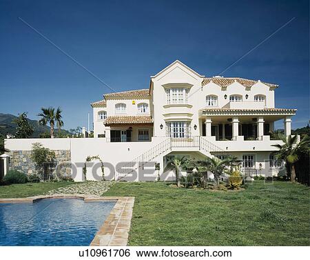 Swimming pool in front of large modern villa in Southern Spain View Large Photo Image Stock Photograph - Swimming pool in front of large modern villa in Southern Spain. Fotosearch