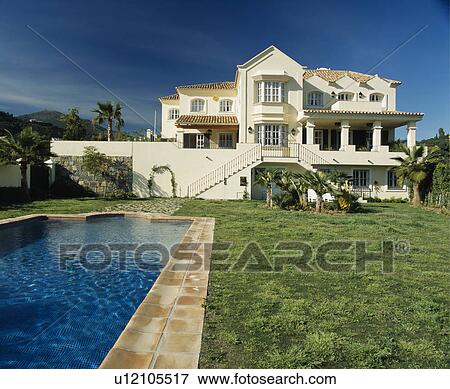 Stock Photo - Swimming pool in front of large villa in southern Spain. Fotosearch