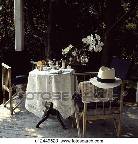 Table and chairs on decked veranda in summer View Large Photo Image Stock Image - Table and chairs on decked veranda in summer. Fotosearch