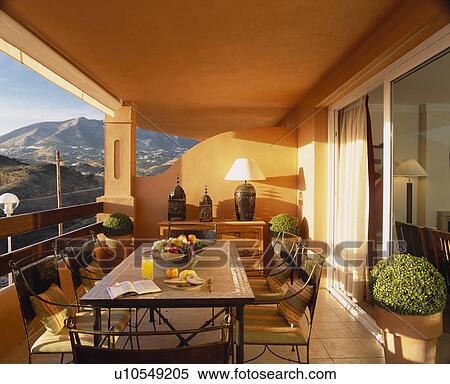 Stock Photography - Table and chairs on veranda of villa in Southern Spain. Fotosearch