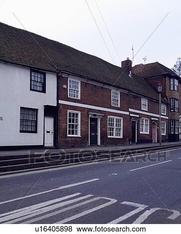 Terraced row of white painted and traditional red brick houses on a village street View Large Photo Image Stock Photo - Terraced row of white painted and traditional red brick houses on a village street. Fotosearch