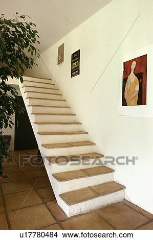 Terracotta tiled treads on freestanding modern white staircase with no bannisters View Large Photo Image Picture - Terracotta tiled treads on freestanding modern white staircase with no bannisters. Fotosearch