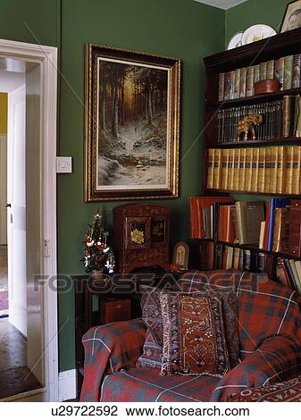 Stock Image - Throw on sofa in traditional living room. Fotosearch