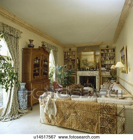 Stock Photo - Throw on sofa in traditional living room. Fotosearch