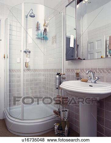 Stock Photo - Tiled corner shower cubicle with glass doors. Fotosearch