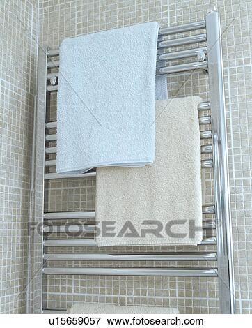 Towel rail against beige mosaic tiles View Large Photo Image Stock Photo - Towel rail against beige mosaic tiles. Fotosearch