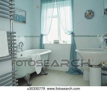 Stock Photo - Traditional blue and white bathroom with roll top bath . Fotosearch