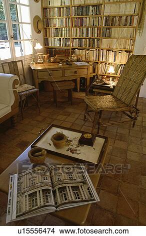 Traditional country living room with with tiled floor and large bookcase View Large Photo Image Picture - Traditional country living room with with tiled floor and large bookcase. Fotosearch