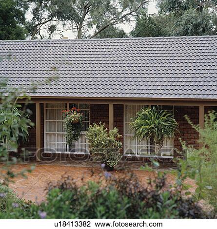 Stock Image - Traditional single-storey newbuild house in the country. Fotosearch