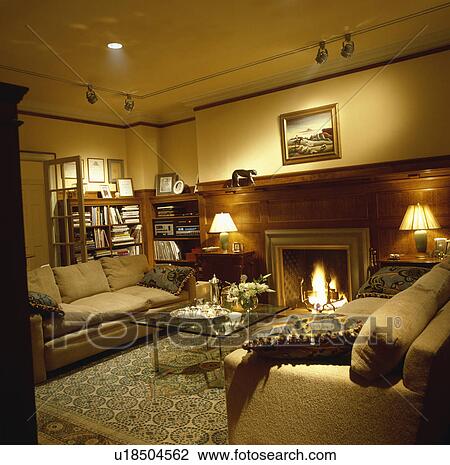 Traditional town living room with lighted lamps View Large Photo Image Stock Image - Traditional town living room with lighted lamps. Fotosearch