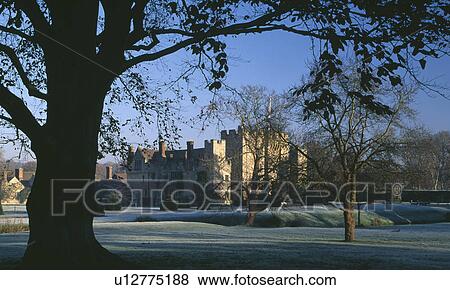 Trees and frosted lawn in garden of large castellated country house in winter View Large Photo Image Stock Photo - Trees and frosted lawn in garden of large castellated country house in winter. Fotosearch