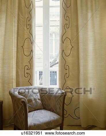 Tub chair and cream curtains View Large Photo Image Stock Image - Tub chair and cream curtains. Fotosearch