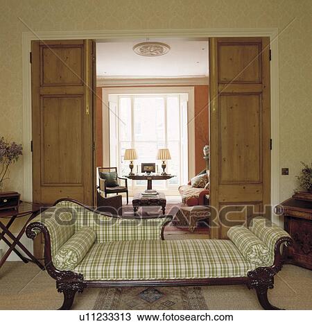 Stock Image - Upholstered chaiselongue in traditional living room. Fotosearch