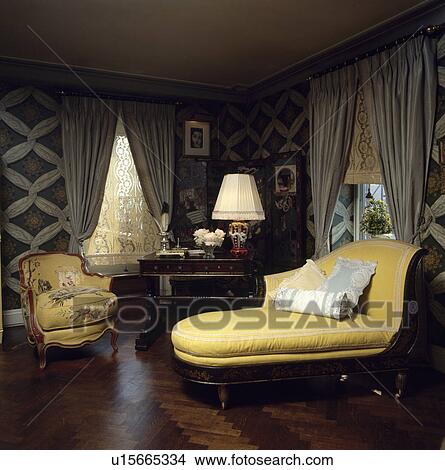 Upholstered yellow chaiselongue in traditional living room View Large Photo Image Picture - Upholstered yellow chaiselongue in traditional living room. Fotosearch