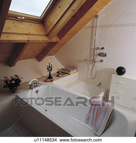 Velux window above narrow bath and shower in compact attic bathroom View Large Photo Image Picture - Velux window above narrow bath and shower in compact attic bathroom. Fotosearch