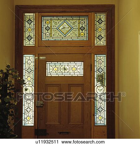 Victorian Stained Glass Panels In Traditional Wooden Front Door Stock Image