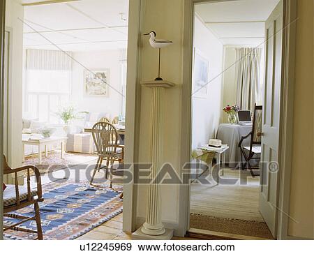 Stock Photo - View from hall of living and dining room in coastal cottage. Fotosearch