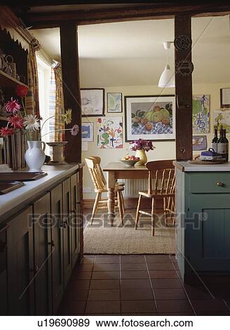 View from kitchen through doorway to cottage dining room with pine table and chairs View Large Photo Image Stock Photo - View from kitchen through doorway to cottage dining room with pine table and chairs. Fotosearch