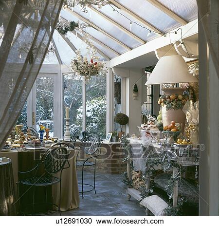 View into conservatory dining room with decorations and table set for Christmas dinner View Large Photo Image Stock Image - View into conservatory dining room with decorations and table set for Christmas dinner. Fotosearch
