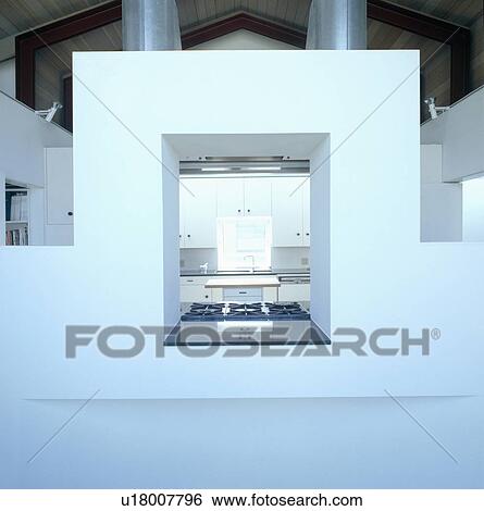 View of kitchen through internal window in modern architectural city house View Large Photo Image Stock Photograph - View of kitchen through internal window in modern architectural city house. Fotosearch