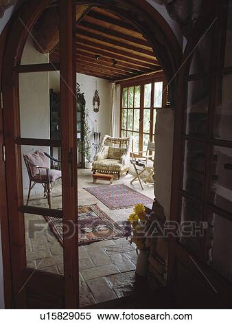 View through glazed door to cottage living room with stone flagged floor View Large Photo Image Stock Photography - View through glazed door to cottage living room with stone flagged floor. Fotosearch