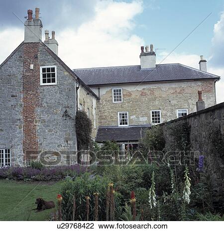 Stock Image - Walled garden and large country house. Fotosearch