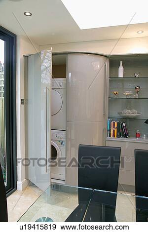 Washing machine and dryer concealed behind double doors in modern grey kitchen View Large Photo Image Stock Photo - Washing machine and dryer concealed behind double doors in modern grey kitchen. Fotosearch