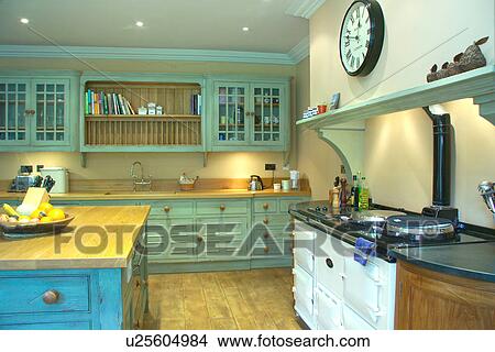 White Aga in contemporary kitchen with turquoise distressed paint effect fitted cupboards View Large Photo Image Picture - White Aga in contemporary kitchen with turquoise distressed paint effect fitted cupboards. Fotosearch