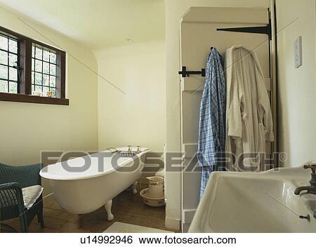 White bathroom showing a roll top bath and basin View Large Photo Image Stock Photograph - White bathroom showing a roll top bath and basin . Fotosearch