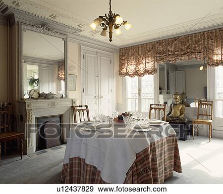 White cloth and tartan cloth on table in grey dining room with tartan festoon blinds and ornate mirror above fireplace View Large Photo Image Stock Photo - White cloth and tartan cloth on table in grey dining room with tartan festoon blinds and ornate mirror above fireplace. Fotosearch