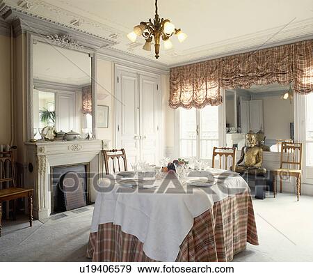 White cloth and tartan cloth on table in grey dining room with tartan festoon blinds and ornate mirror above fireplace View Large Photo Image Stock Photo - White cloth and tartan cloth on table in grey dining room with tartan festoon blinds and ornate mirror above fireplace. Fotosearch