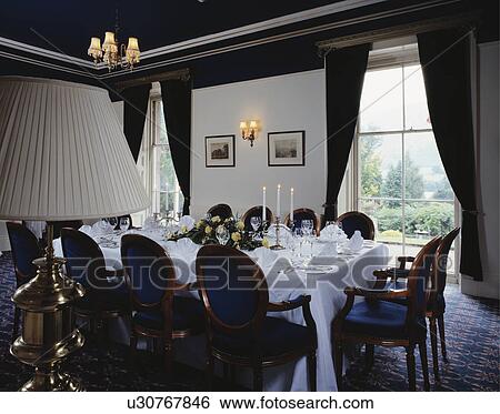 White cloth on large table in hotel dining room View Large Photo Image Stock Photograph - White cloth on large table in hotel dining room. Fotosearch