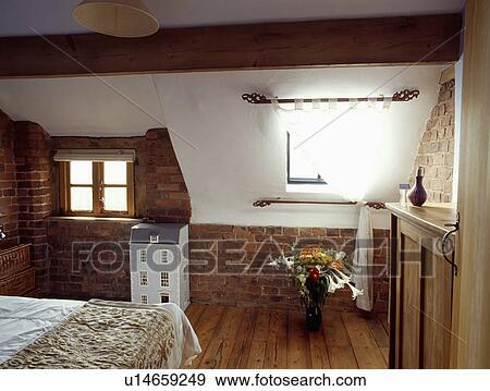 White Curtain On Window In Attic Bedroom With Wooden Flooring And