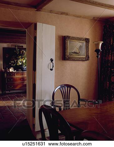 White folding door in terracotta cottage dining room View Large Photo Image Stock Image - White folding door in terracotta cottage dining room . Fotosearch