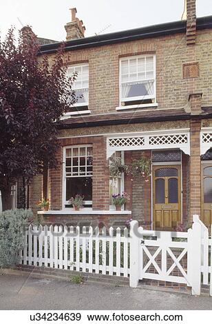 White gate and picket fence in front of Victorian terraced cottage with white woodwork above porch View Large Photo Image Stock Photo - White gate and picket fence in front of Victorian terraced cottage with white woodwork above porch. Fotosearch