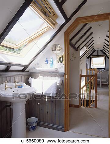 White pedestal basin below Velux window in attic bathroom with open door to landing with white carpet View Large Photo Image Stock Image - White pedestal basin below Velux window in attic bathroom with open door to landing with white carpet. Fotosearch