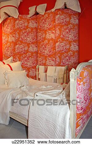 White quilt and linen on pink and orange upholstered bed in front of matching folding screen View Large Photo Image Stock Image - White quilt and linen on pink and orange upholstered bed in front of matching folding screen. Fotosearch