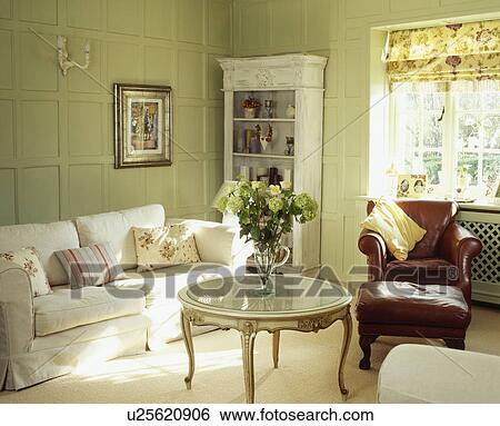 White sofa in pastel green panelled country living room View Large Photo Image Stock Photograph - White sofa in pastel green panelled country living room. Fotosearch
