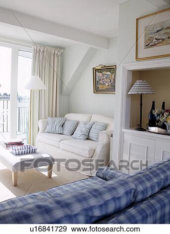 Stock Photo - White sofa in small coastal living room. Fotosearch