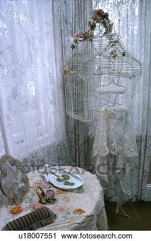 White Victorian birdcage decorated with porcelain roses and lace in front of window with lace curtains View Large Photo Image Stock Image - White Victorian birdcage decorated with porcelain roses and lace in front of window with lace curtains. Fotosearch